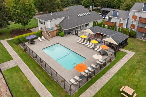 A pool surrounded by a fence and chairs. A pool surrounded by a fence and chairs. at Northpoint Apartments, Tacoma