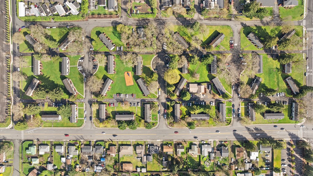 A bird's eye view of a residential area with houses and roads.