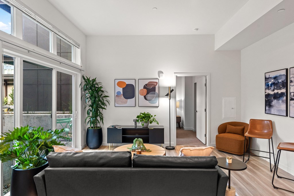a living room with a couch and a coffee table and a large window