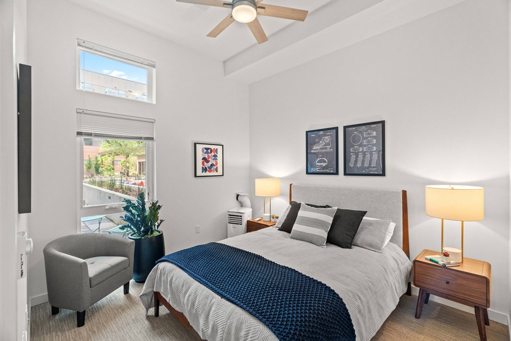 a bedroom with a large bed and a ceiling fan