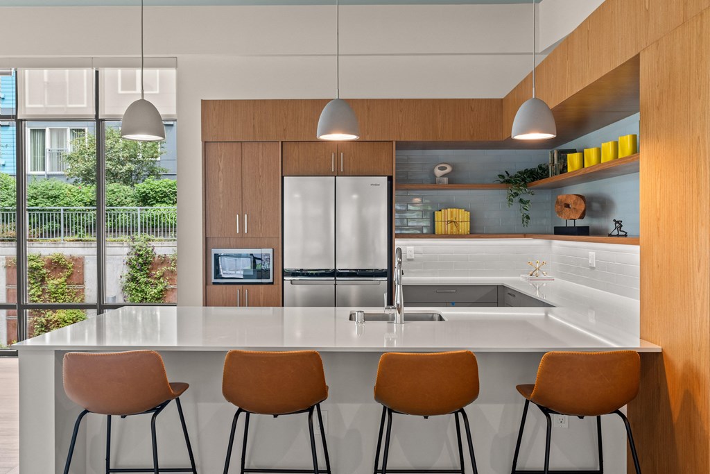 a kitchen with a large island and four chairs