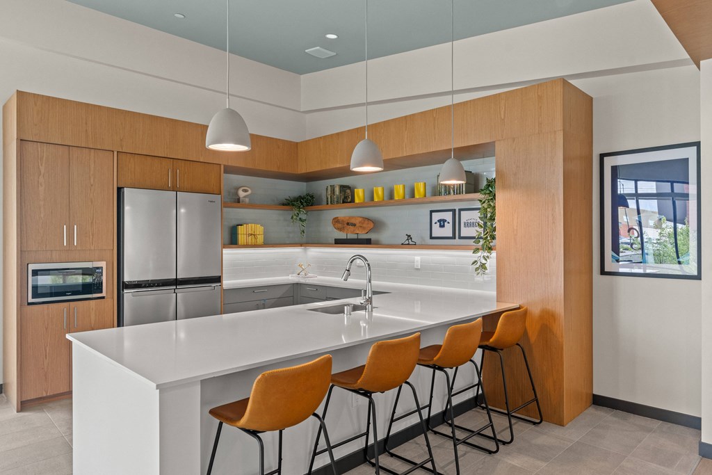 a kitchen with a large island with four stools
