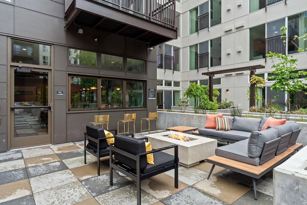 a living room with couches and chairs and a table in front of a building