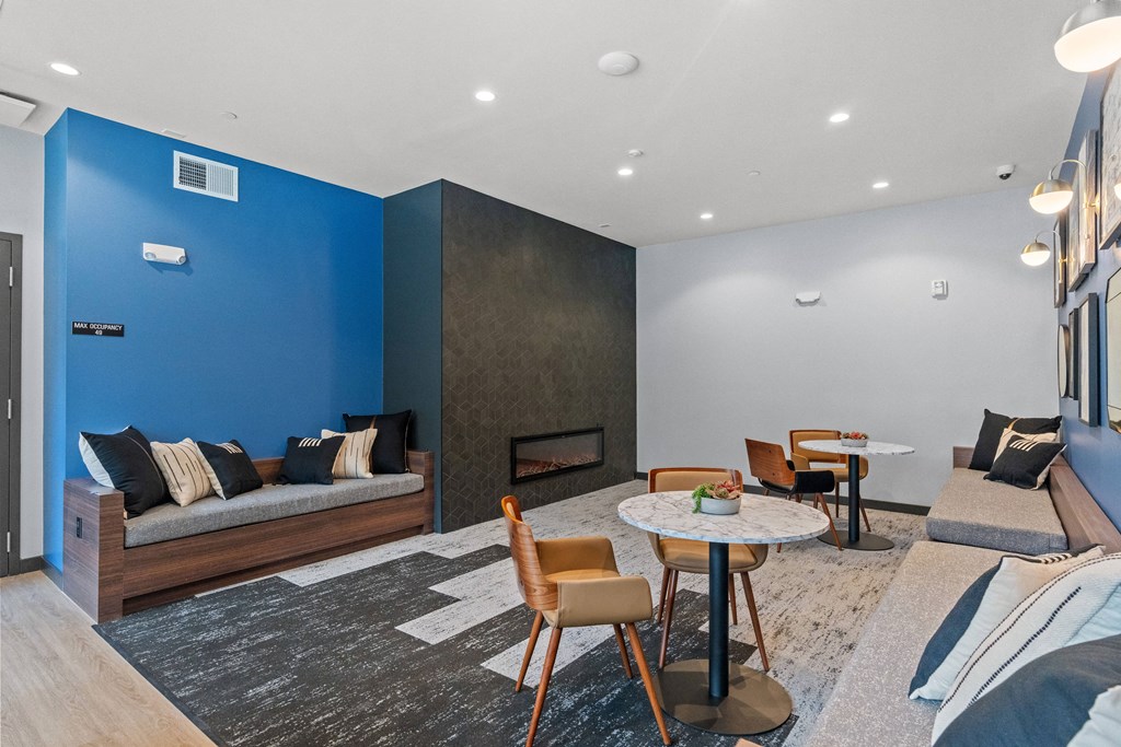 a living room with a blue accent wall and a fireplace