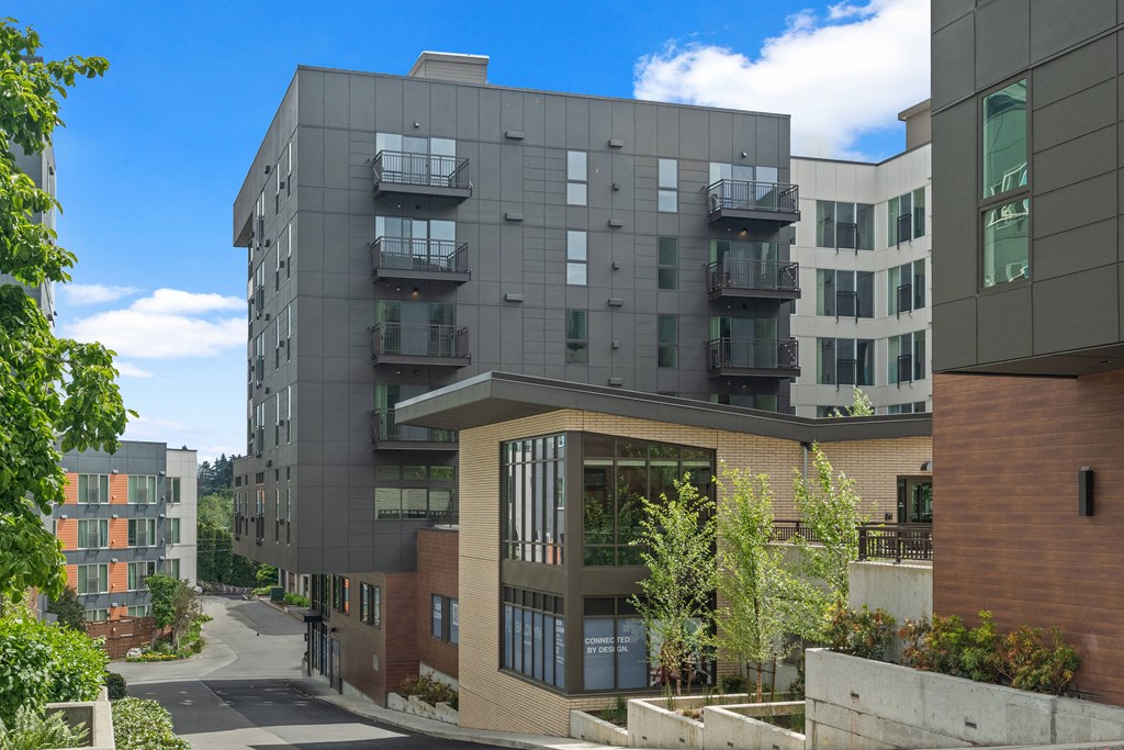 a view of an apartment building with a street in front of it