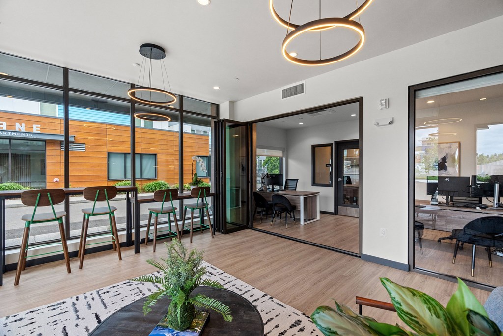 a living room with glass sliding doors and a dining room with a table and chairs