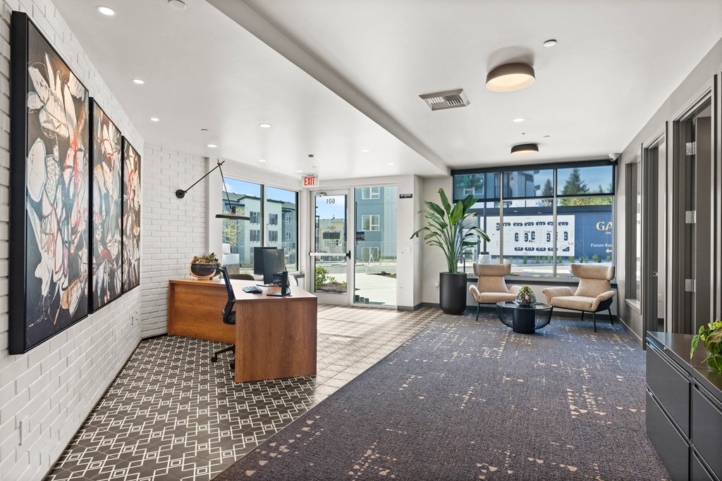 an office lobby with a desk and a large window