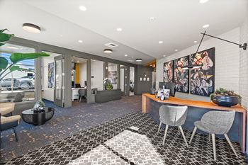 a conference room with a desk and chairs and a large window at Gage On Sixth, Tacoma