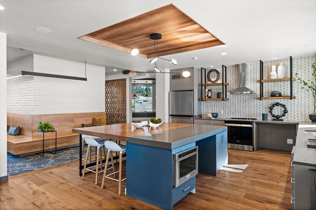 a kitchen with a blue island and a wood floor
