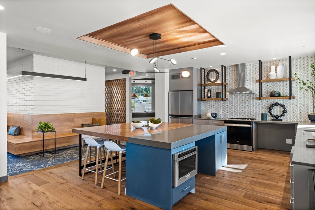 a kitchen with a blue island and a wood floor