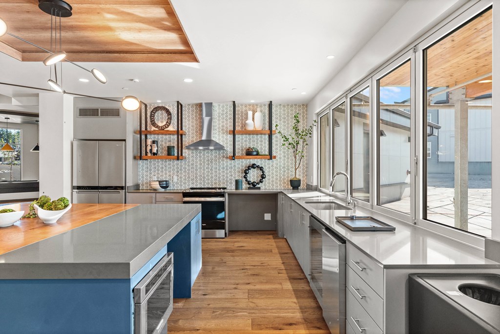 a large kitchen with stainless steel counter tops and stainless steel appliances