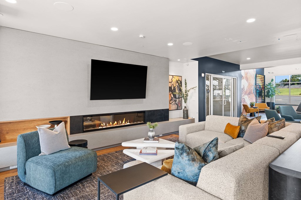 a living room with couches and chairs and a fireplace