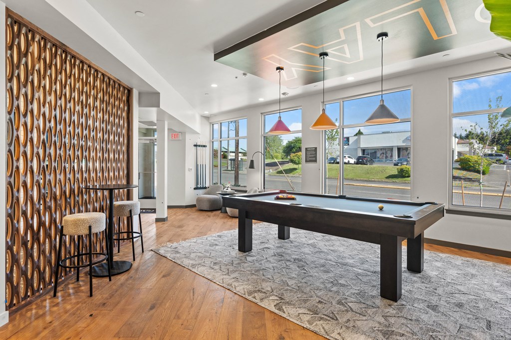 an open living room with a pool table and a dining area