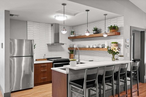 A modern kitchen with a stainless steel refrigerator and a white countertop. A modern kitchen with a stainless steel refrigerator and a white countertop. at Northpoint Apartments, Washington