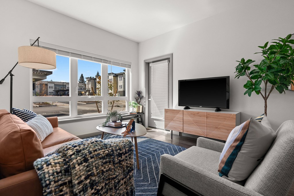 a living room with a couch and a tv and a window at Gage On Sixth, Tacoma, 98406