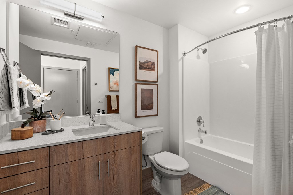 a bathroom with a shower toilet and sink and a mirror at Gage On Sixth, Tacoma, 98406