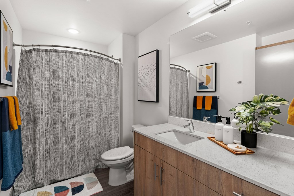 a bathroom with a shower and a sink and a toilet at Gage On Sixth, Washington, 98406