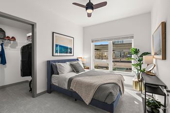 a bedroom with a bed and a ceiling fan at Gage On Sixth, Tacoma