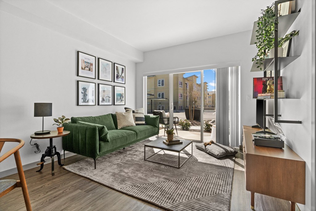 a living room with a green couch and a window at Gage On Sixth, Tacoma Washington