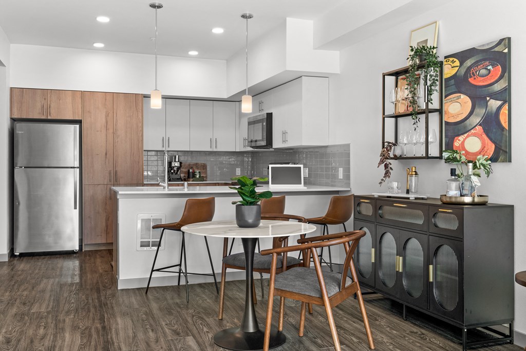 an open kitchen and dining area with a table and chairs at Gage On Sixth, Tacoma, WA 98406