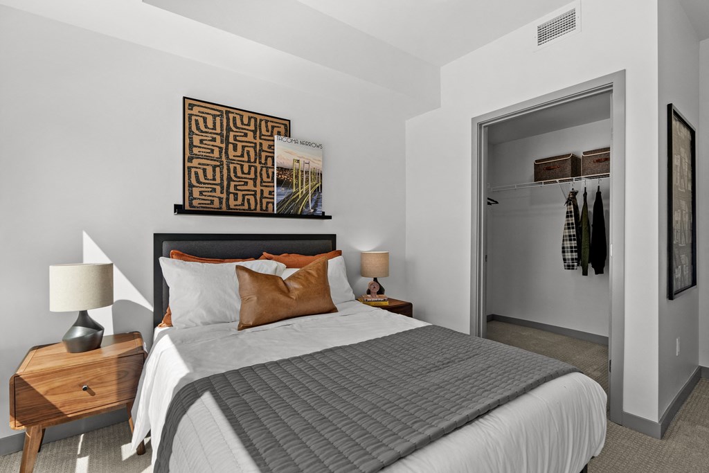 a bedroom with a large bed and a closet at Gage On Sixth, Washington, 98406