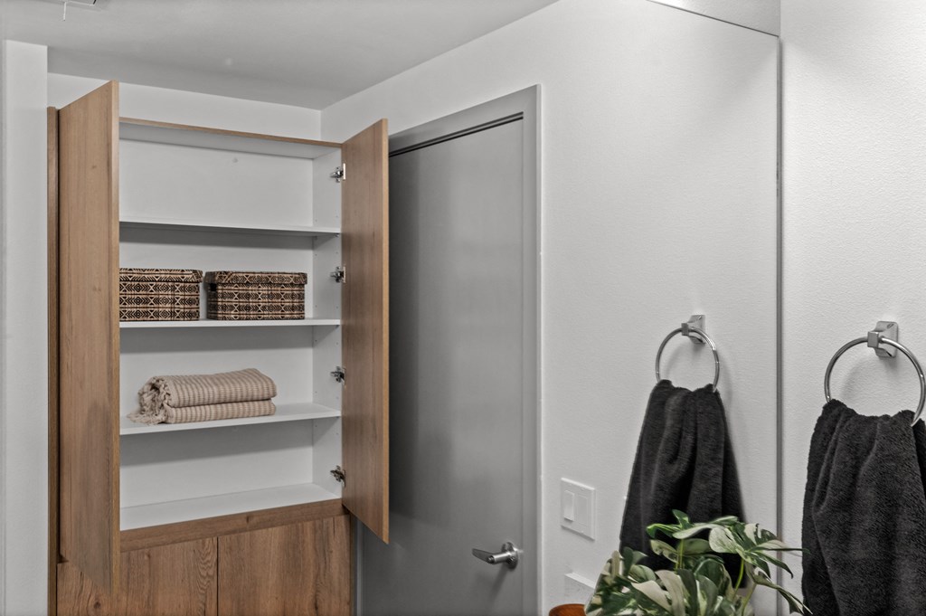 a small bathroom with a closet and a door to the shower at Gage On Sixth, Tacoma