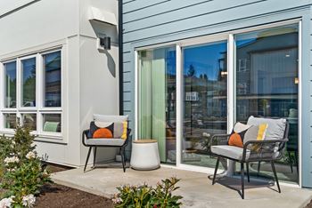 a patio with two chairs and a table outside a house at Gage On Sixth, Tacoma Washington