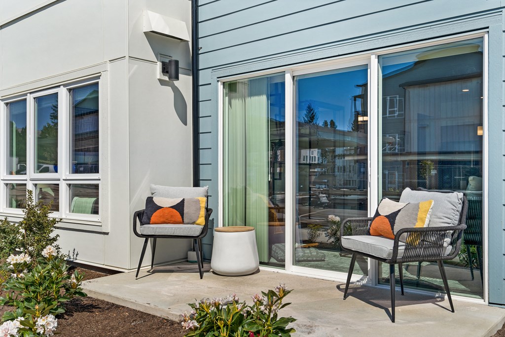 a patio with two chairs and a table outside a house at Gage On Sixth, Washington