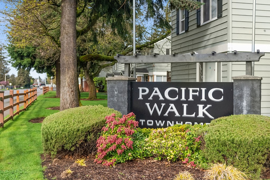 A sign that says Pacific Walk in front of a building.
