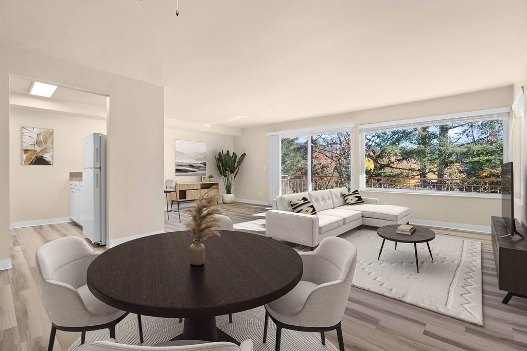 A modern dining room with a round table and chairs.