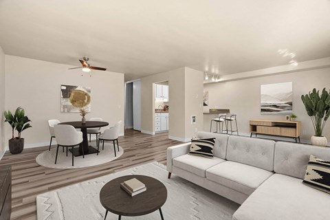 A modern living room with a white couch and a round table.