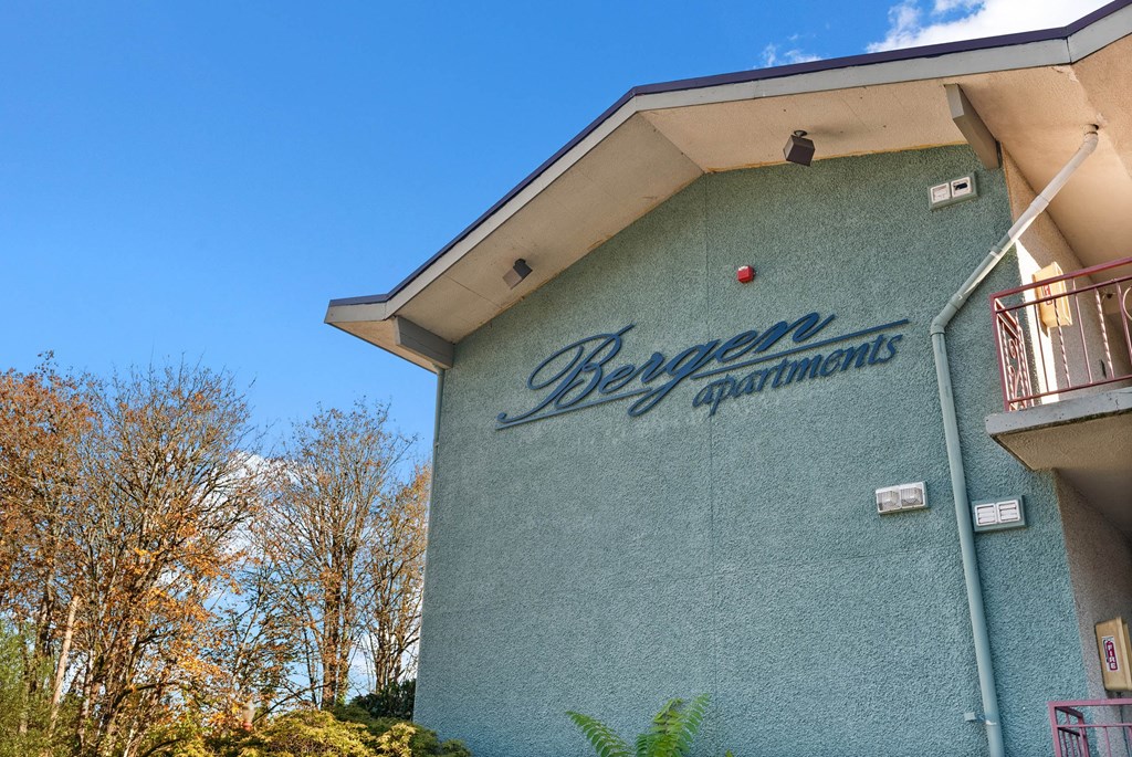 A blue building with the words Bergen Apartments on it.