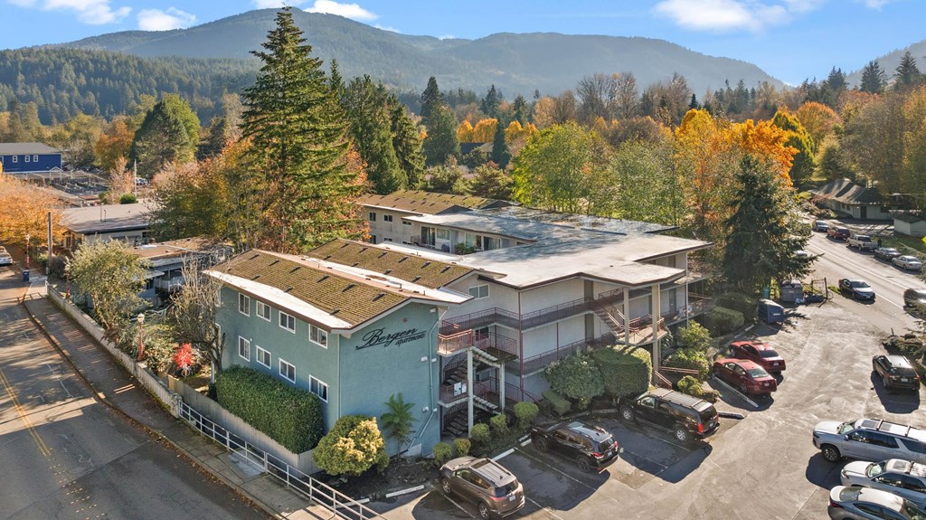 A parking lot with cars and a building in the background.