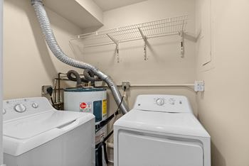A white washing machine and dryer in a small laundry room.