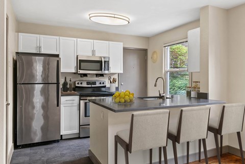 A kitchen with a refrigerator, stove, and oven.