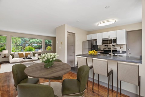 A modern kitchen with a dining table and chairs.