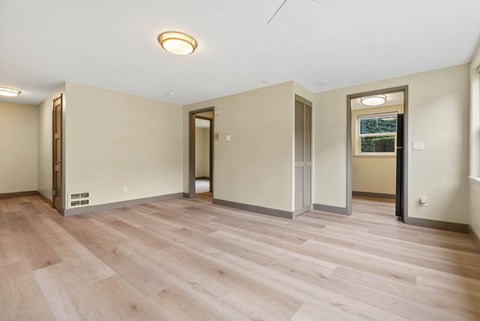 A room with wooden flooring and a ceiling light.