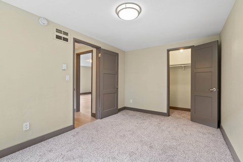 A room with a carpeted floor and a ceiling light.