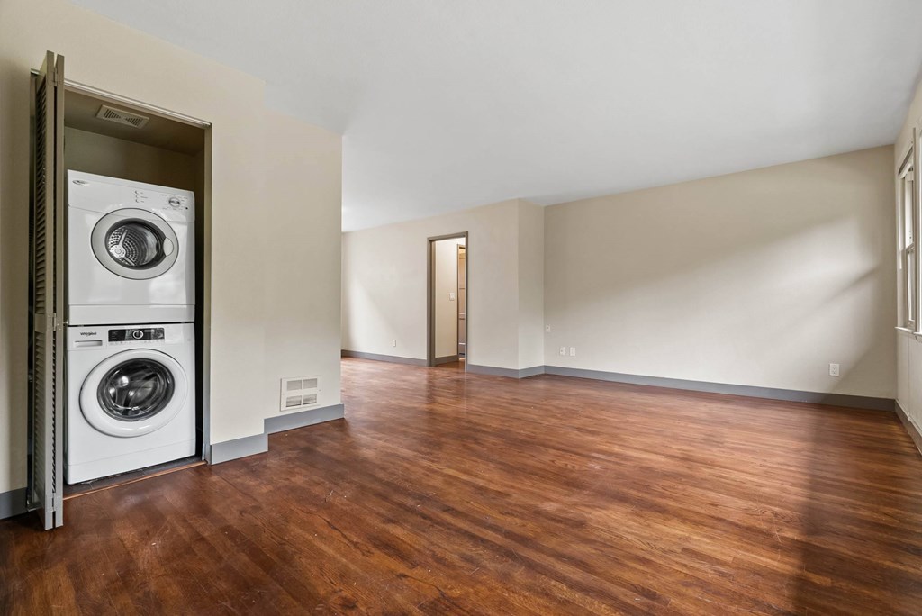 A room with a washer and dryer in the doorway.