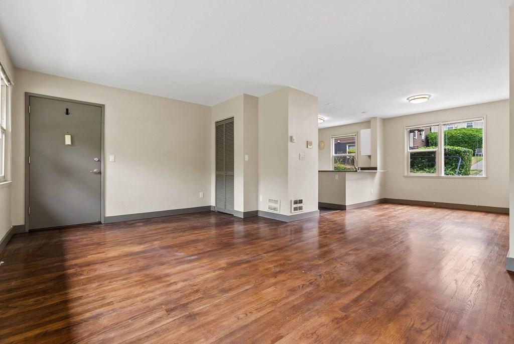 A room with wooden floors and white walls.