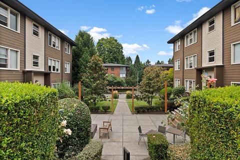A sunny day at a residential area with apartment buildings and a garden.