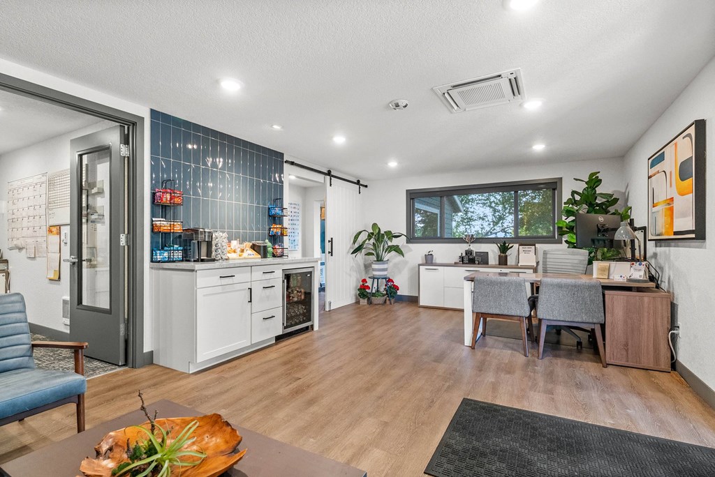 A modern kitchen with a dining table and chairs.