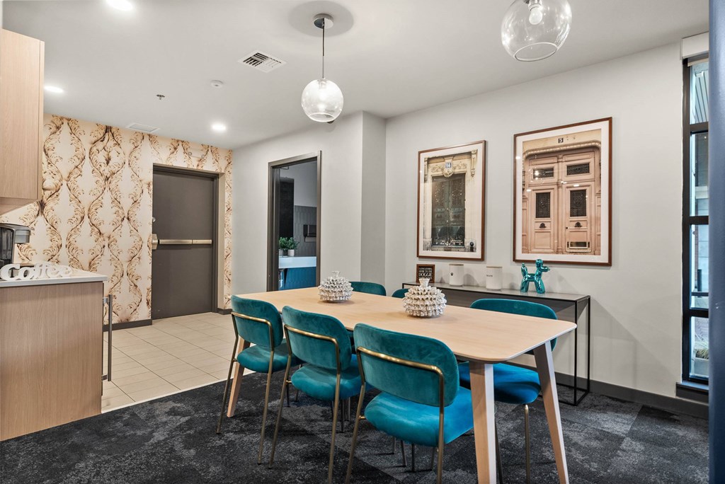 A dining room with a table set for four.