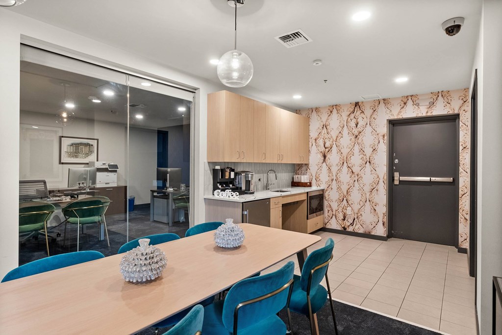 A modern kitchen with a dining table and chairs.