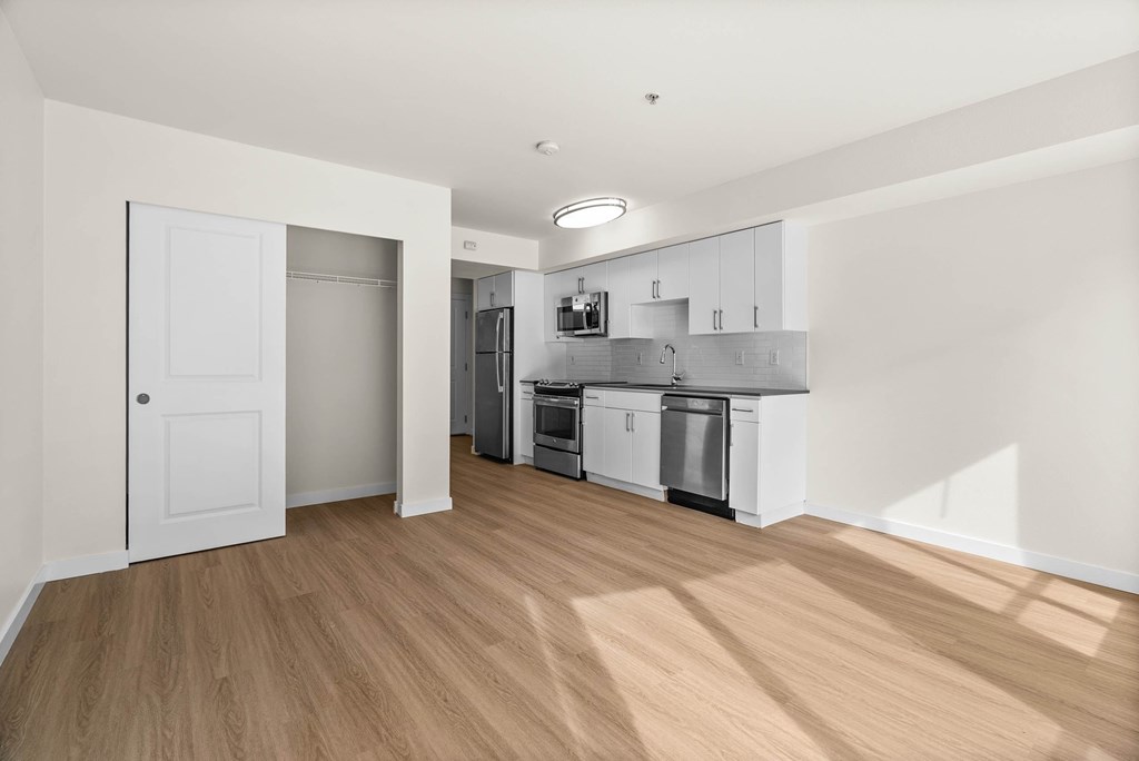 A kitchen with white cabinets and appliances is shown.