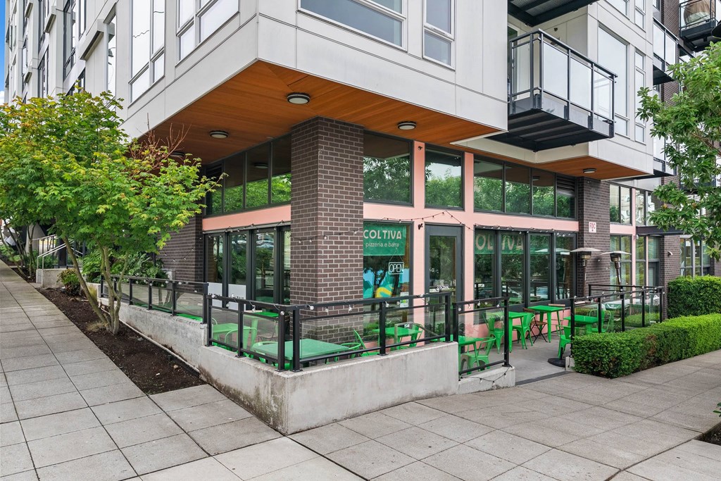 A modern building with a glass facade and a wooden roof.