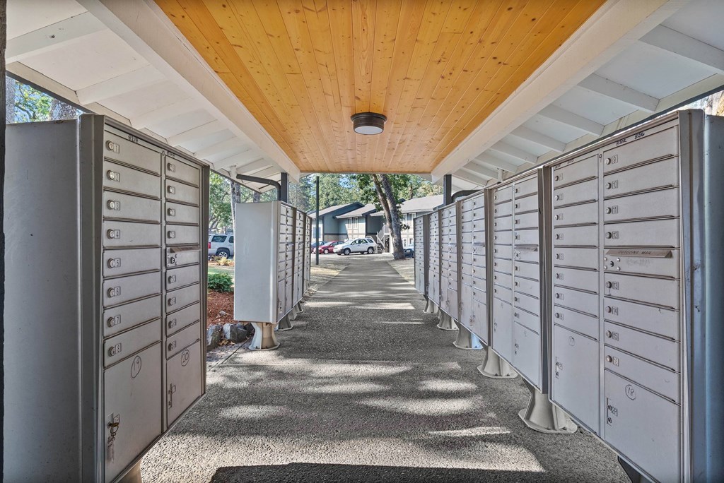 A long corridor with a row of mailboxes on either side.