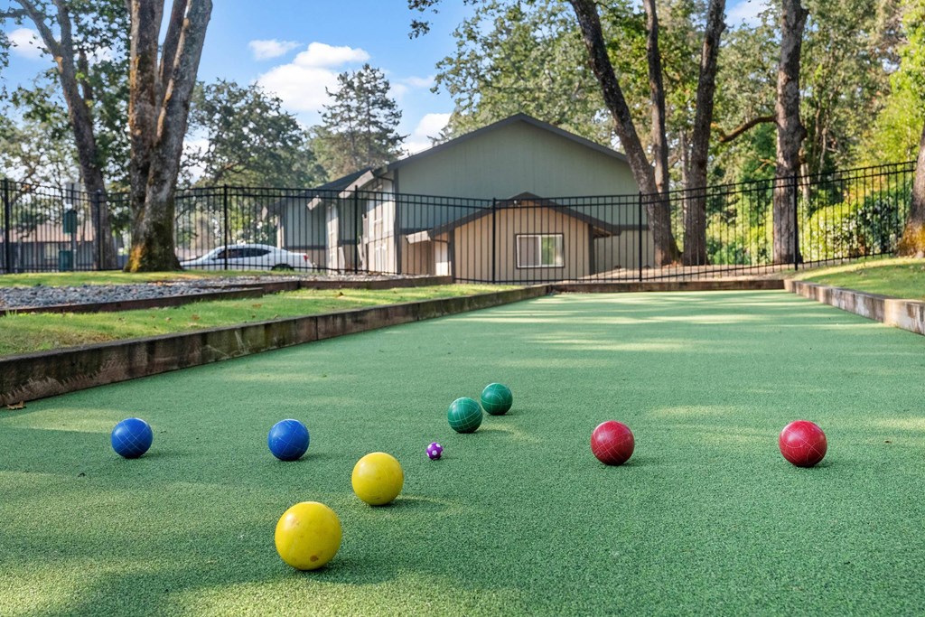 A miniature golf course with a house in the background.