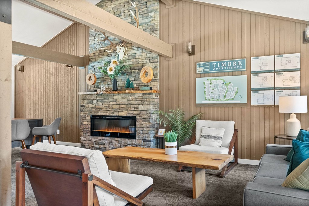A living room with a stone fireplace and a wooden chair.