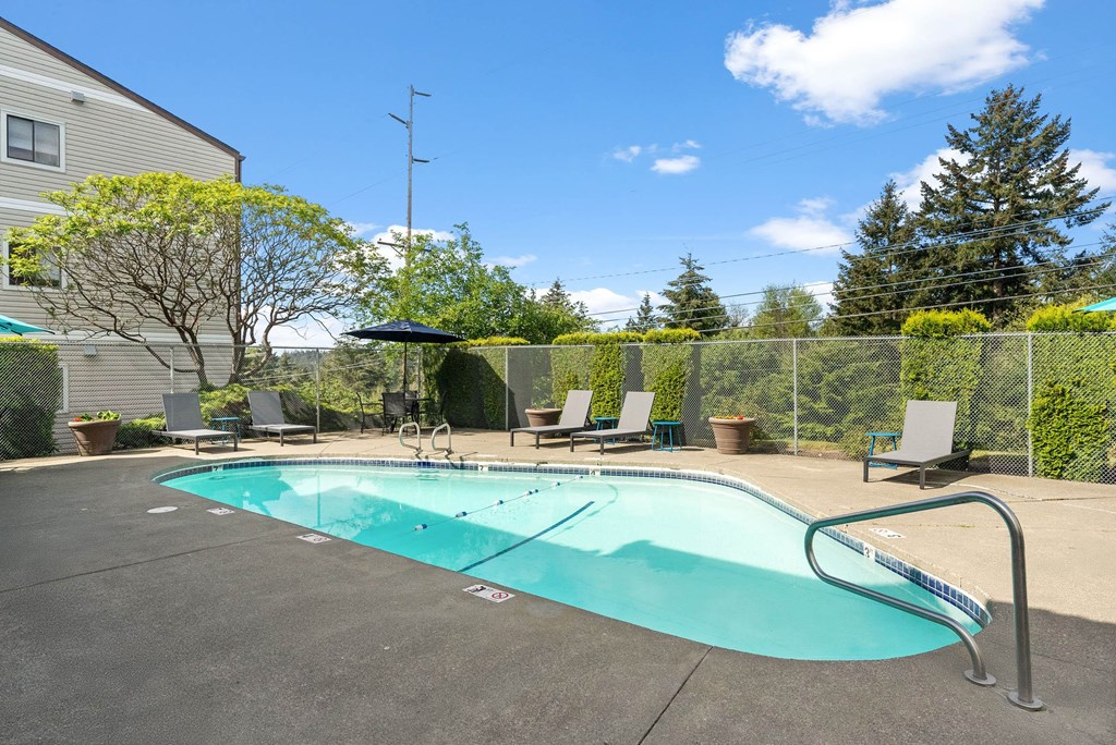 A small pool with a metal fence around it.